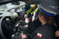 Policjant i uczennice PZS w Lędzinach podczas &quot;Dnia przedsiębiorczości&quot;